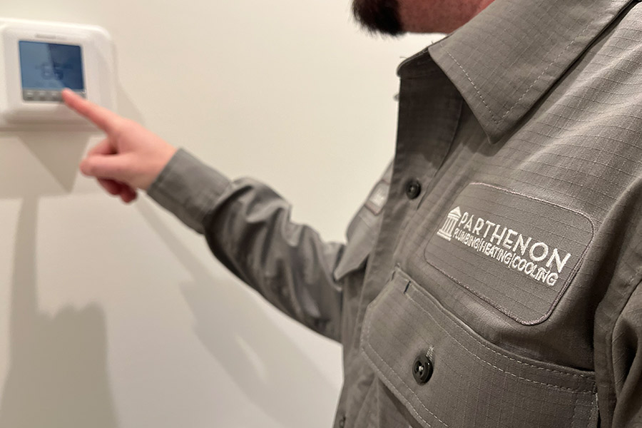 Service technician sets home thermostat to desired setting