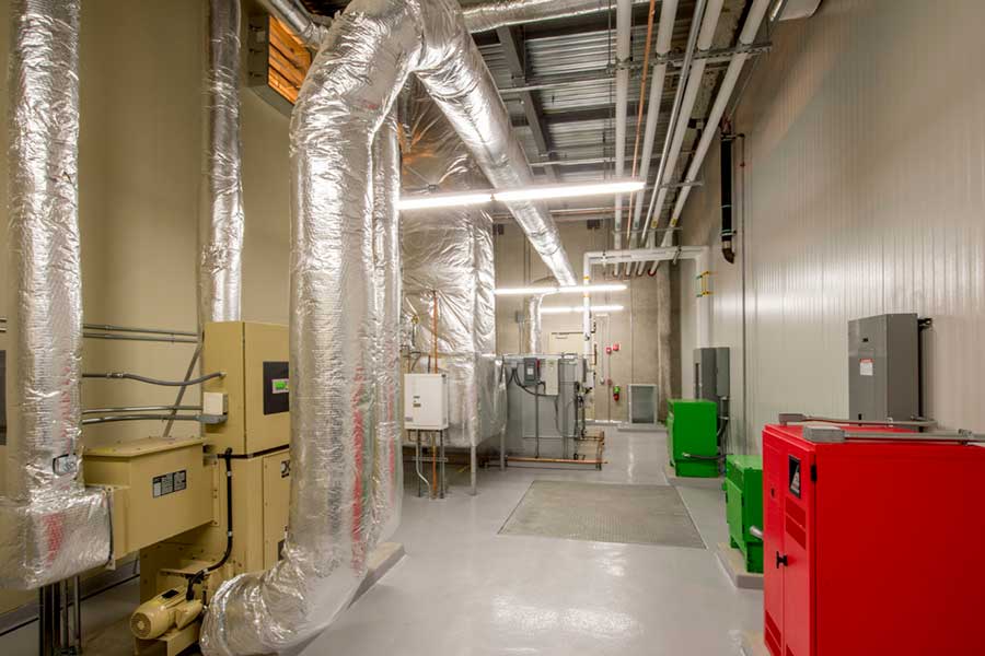 Commercial HVAC room with ductwork and ventilation units