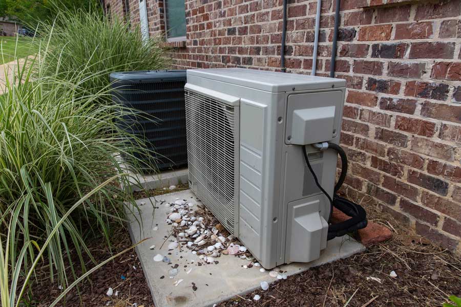 Outdoor HVAC units installed near a brick
