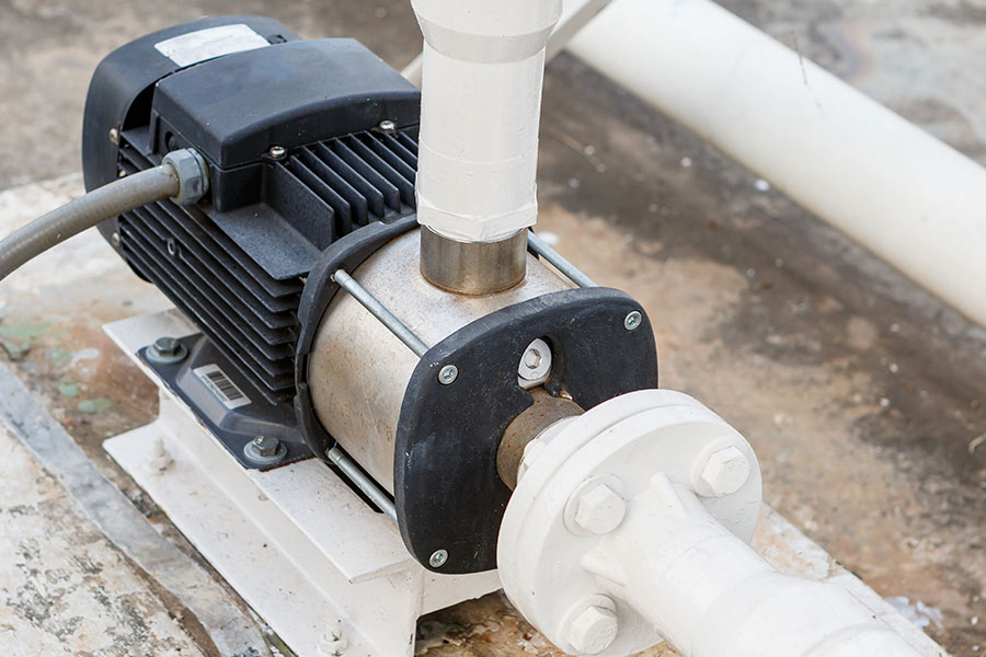 Water pump connected to white pipes