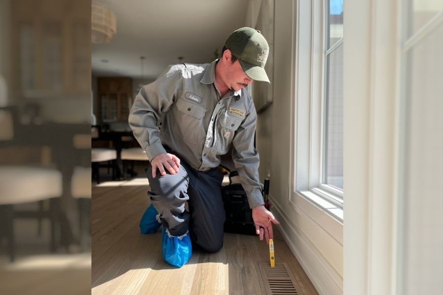 Technician testing air temperature at vent in Hendersonville