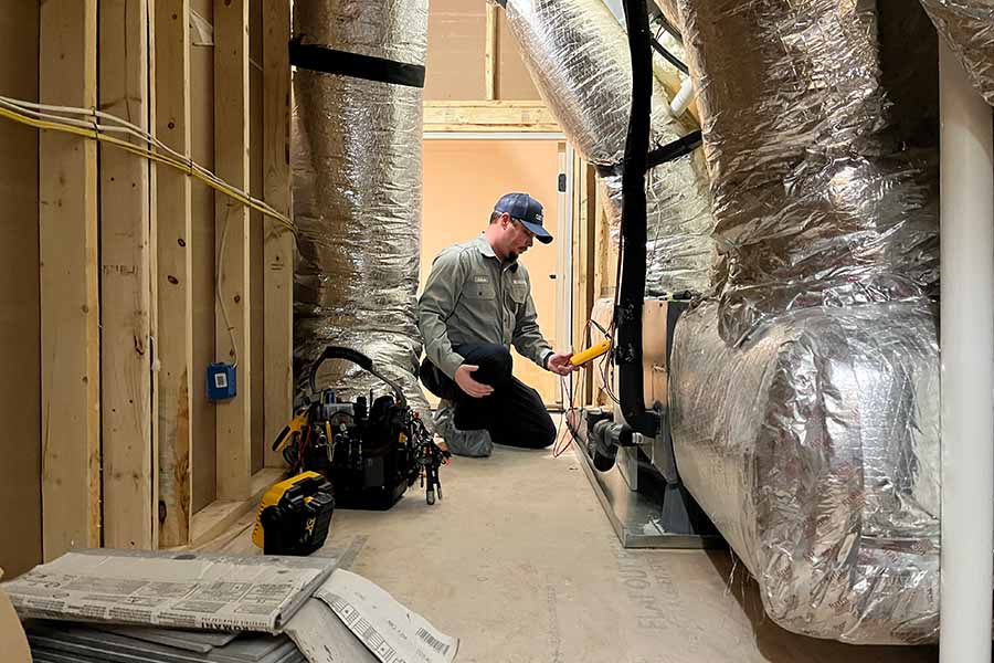 Technician working on HVAC ducts