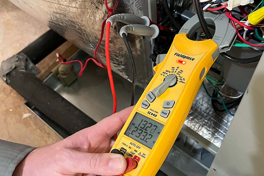 Technician using a Fieldpiece multimeter