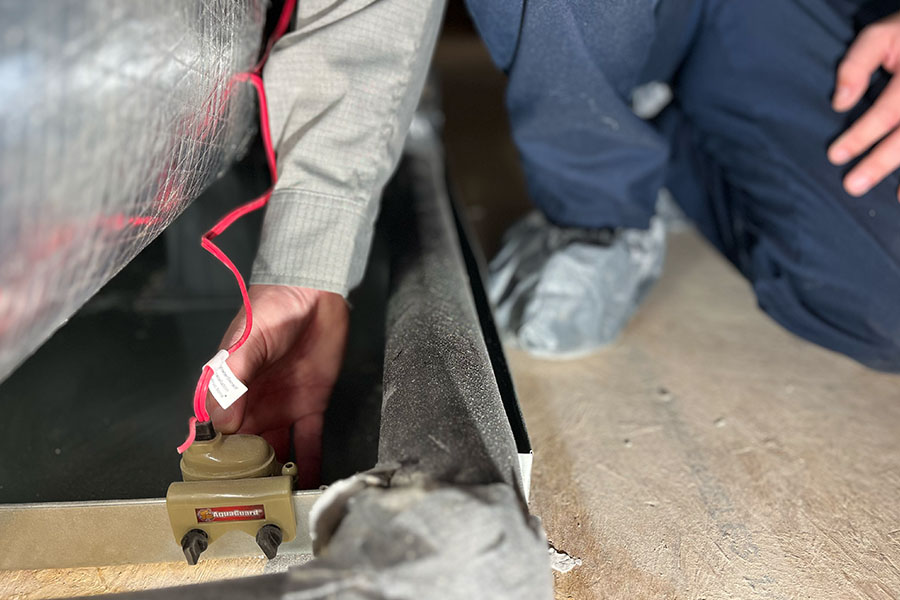 Technician using a digital gauge to inspect HVAC system