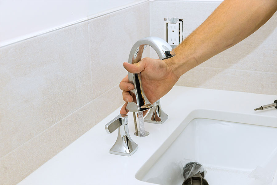 Sink plumbing inspection showing faucet hardware being checked during service