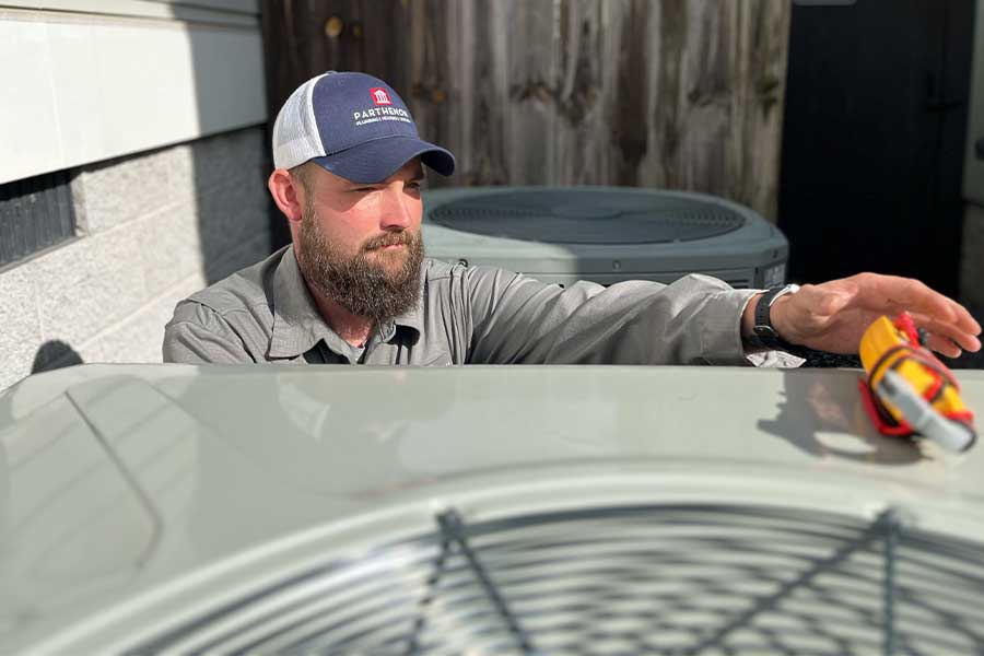 Parthenon HVAC technician repairing outdoor unit in Nashville, TN